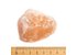 Photo of a pink Ayurvedic salt chunk. Below is a scale, so you can see that the chunk is about six centimeters.